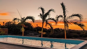 A rectangular swimming pool with clear water, surrounded by a wooden deck. - Santa Maria Inn (Sao Miguel do Gostoso)