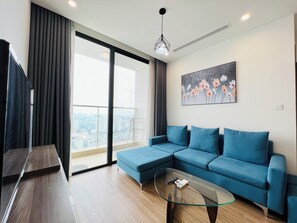 Luxury Apartment, 1 Queen Bed, City View | Living area | 55-inch LED TV with cable channels