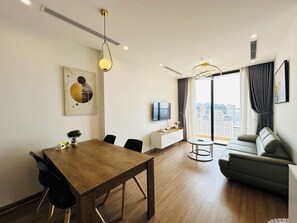 Luxury Apartment, 1 Queen Bed, City View | Living area | 55-inch LED TV with cable channels