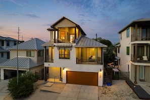 A two-story residential building with a garage, a balcony, and a covered outdoor seating area. - Central Austin Hotspot Walk to Fine Dining & Fun (Austin)