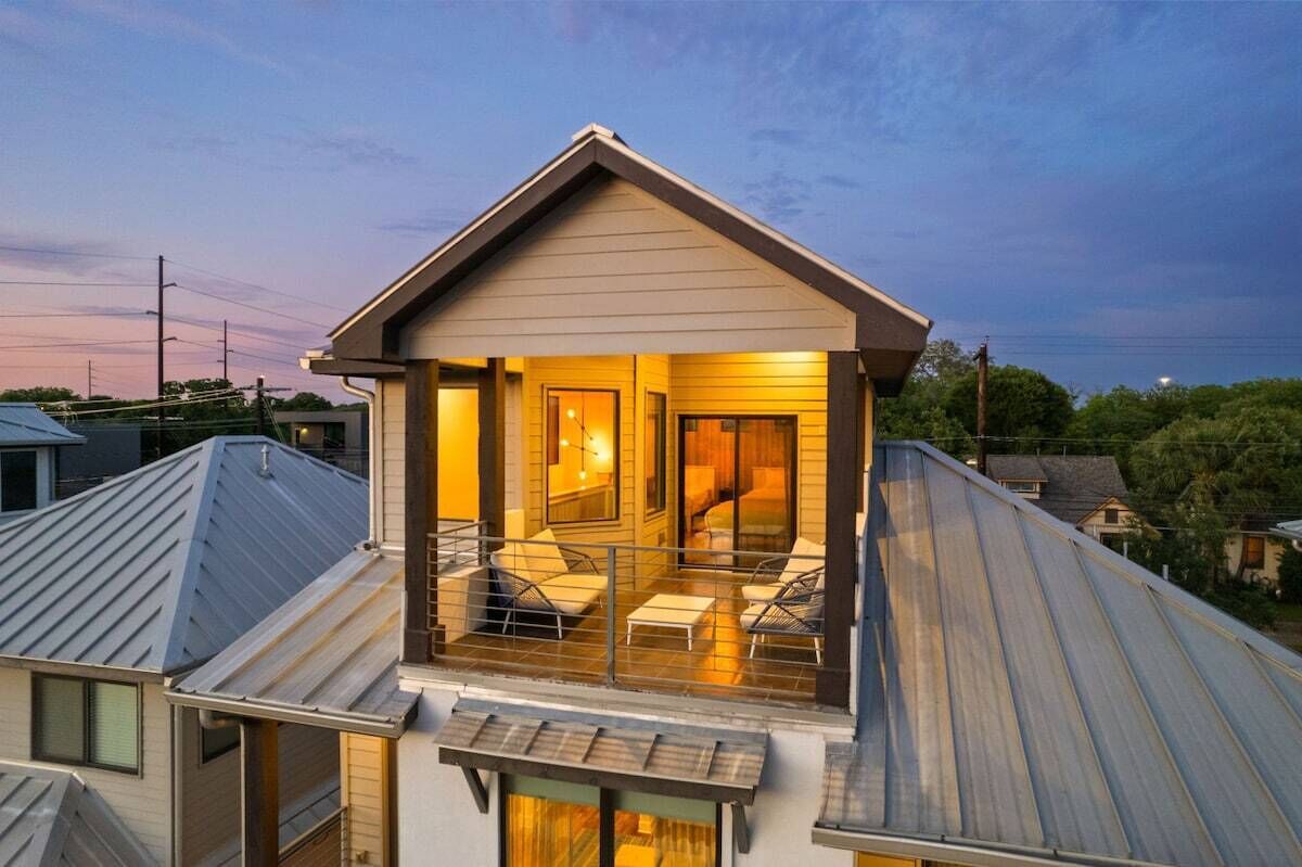 A residential building with a balcony, a door, and a window.