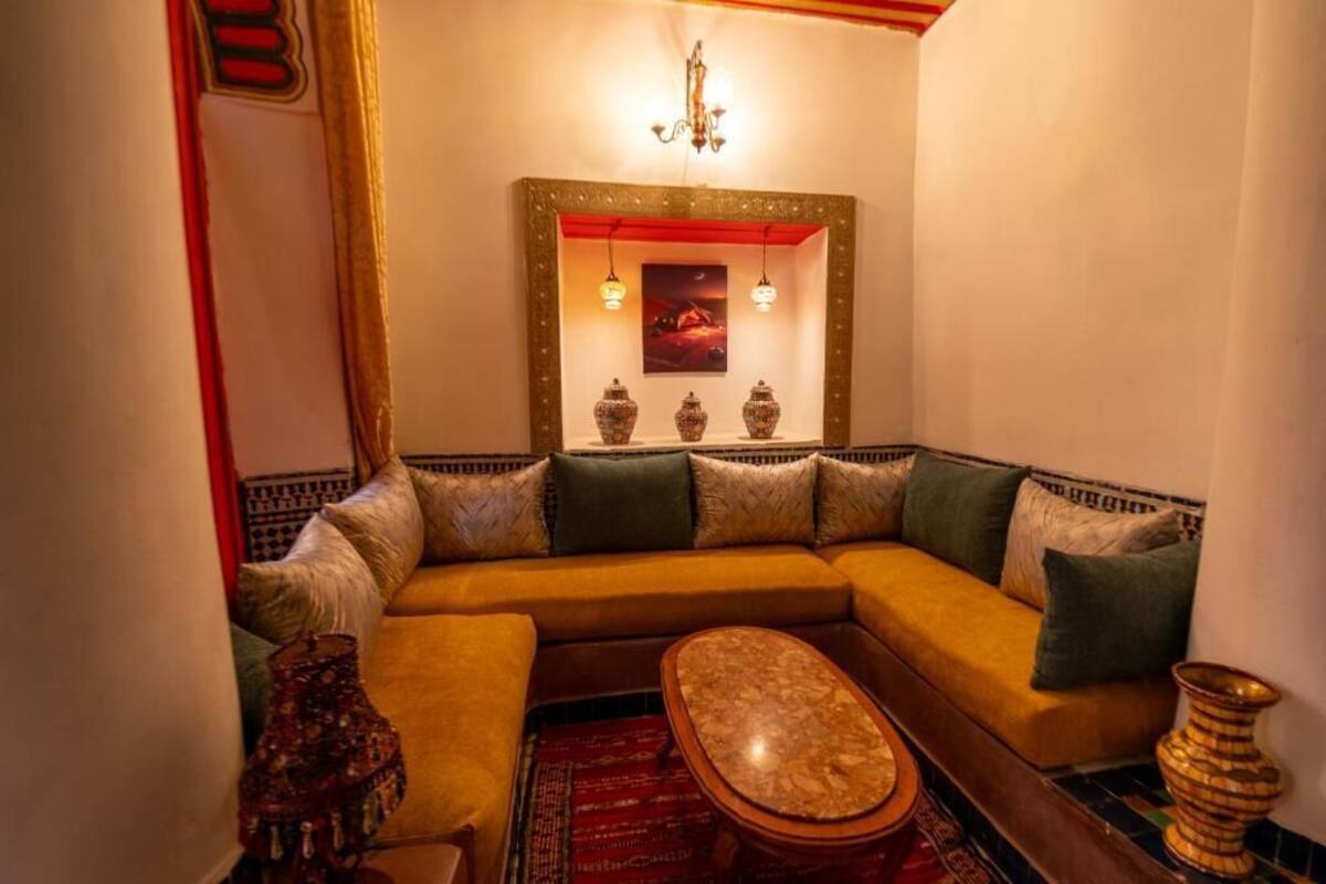 A cozy living room with a sofa, a coffee table, and decorative vases.