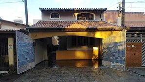 A gated entrance with a tiled roof and a small window above the door.