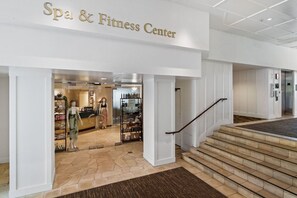 The entrance to a spa and fitness center with a staircase leading up to the entrance.