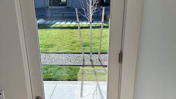 A white door with a glass panel, a metal handle, and a peephole.
