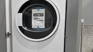 A stacked washer and dryer unit with an ENERGY STAR label, a digital display, and a control panel with various settings. - YVR Stay - Vancouver YVR (Richmond)