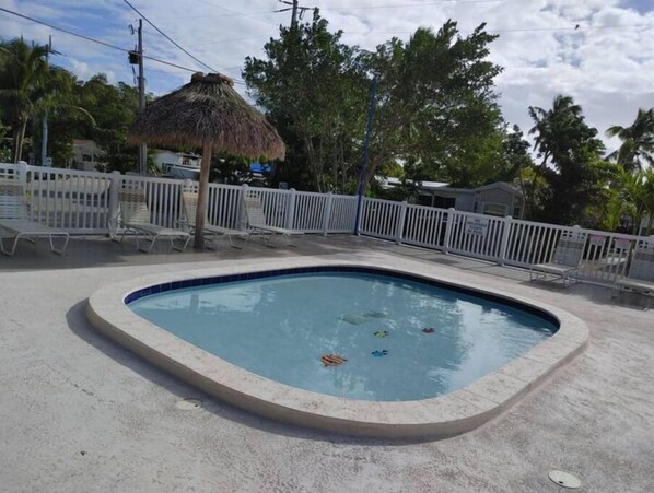 A small, round swimming pool with a white fence surrounding it. - 146 RV Vacation Rental n Key Largo Kampground, FL (Key Largo)