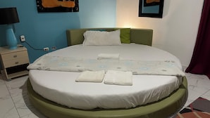 A neatly made bed with a green headboard, white bedding, and multiple pillows. - DREAM VACATION HOME (Sosúa)