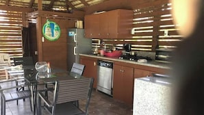A kitchen with a dining table and chairs, a refrigerator, a dishwasher, and a stove. - DREAM VACATION HOME (Sosúa)