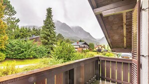 A wooden balcony with a view of a mountainous landscape and houses. - Landhaus Kunze by Interhome (Gröbming)