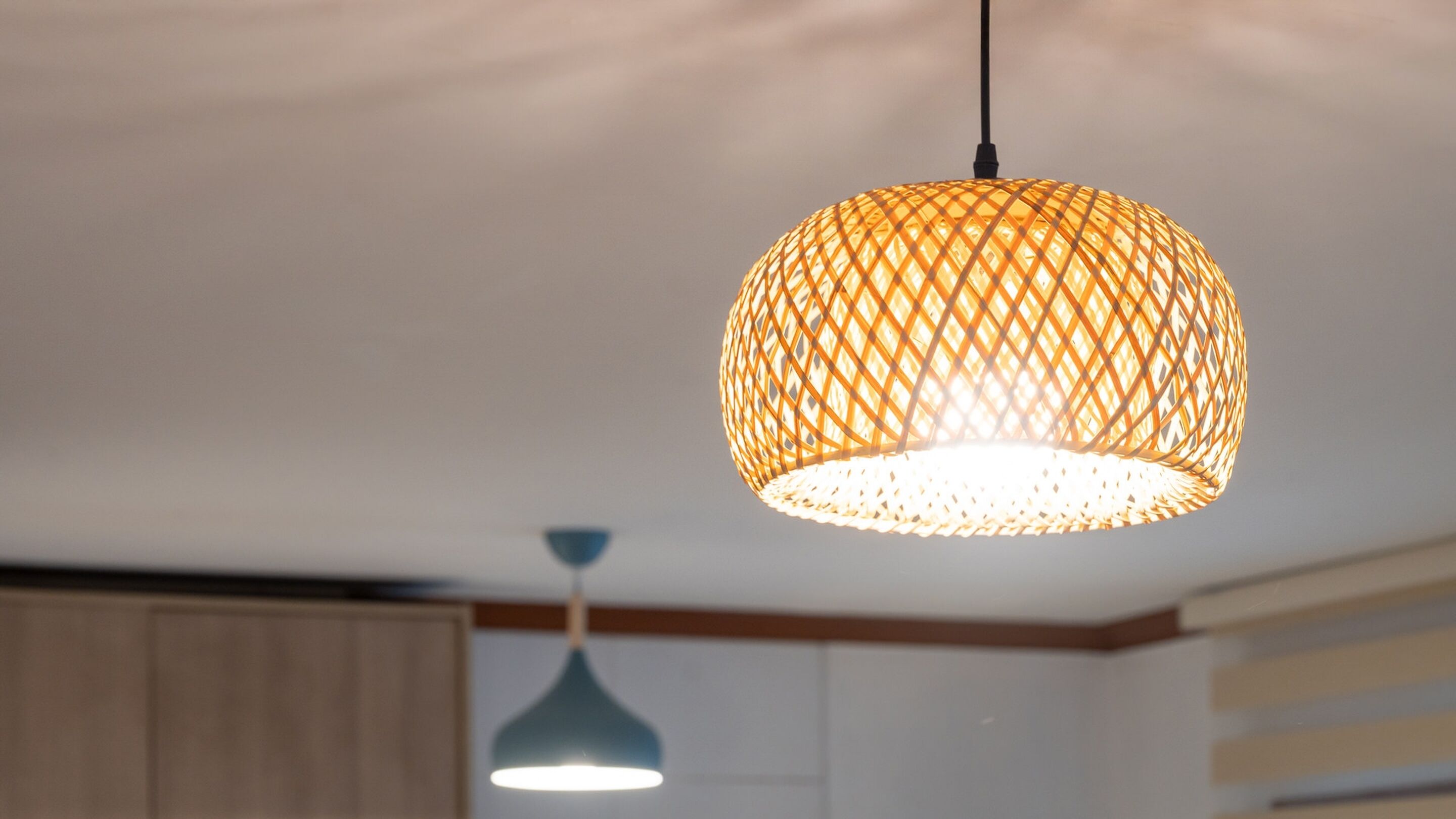 A hanging lamp with a woven, lattice design.