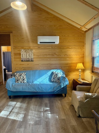 Living area. Charming cabin nestled in the woods in Andalusia, AL