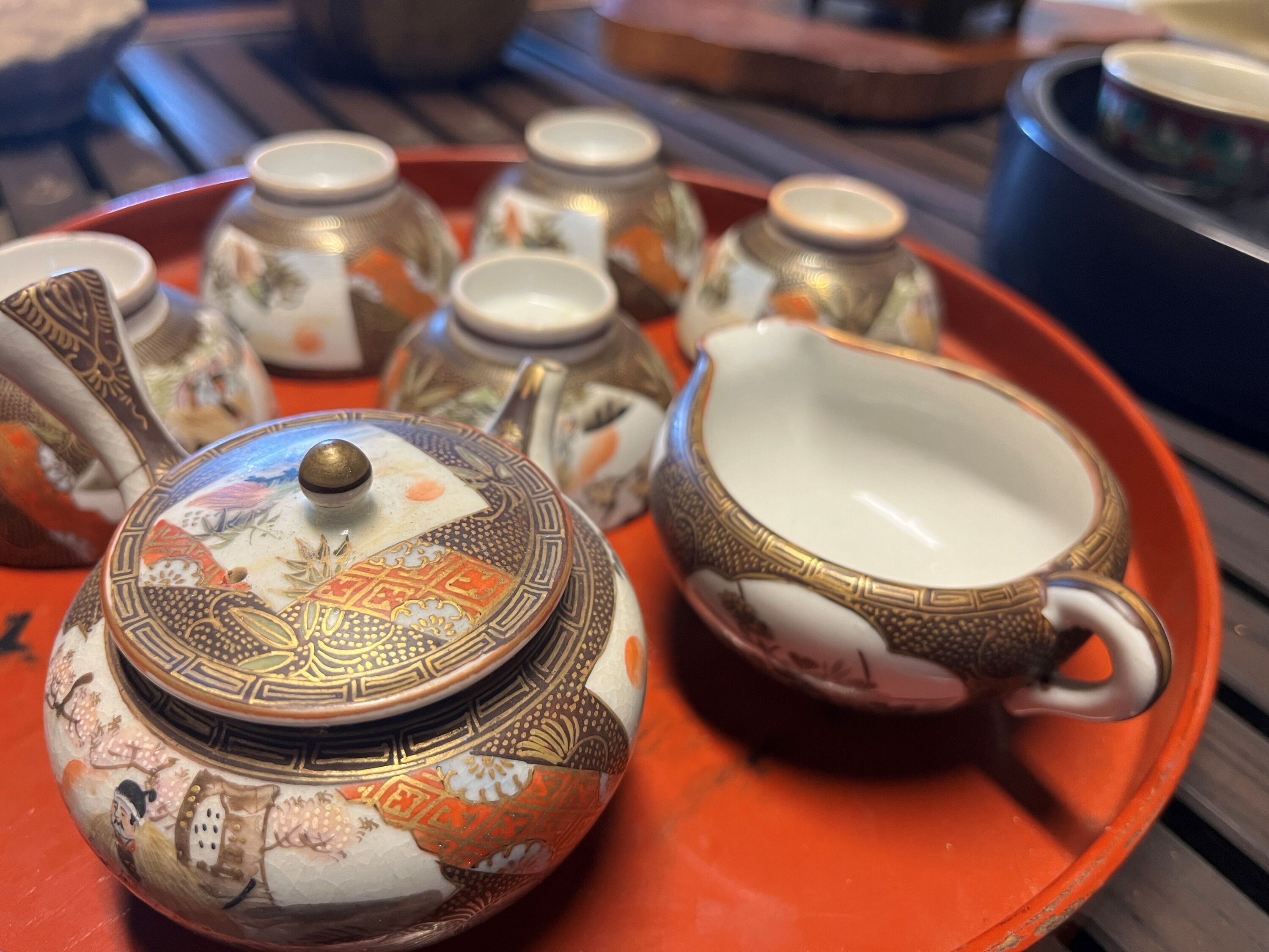 A tray with a teapot, cups, and a teacup.