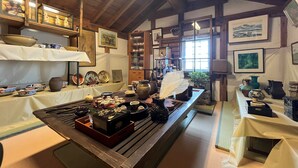 A traditional Japanese room with tatami flooring, wooden beams, and a low ceiling. - HatagoyaChuube (Hakui)