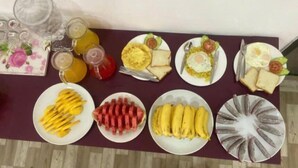 A breakfast buffet with various dishes and drinks. - VANG VIENG VICTORY HOSTEL  (Vang Vieng)
