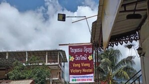 A hostel named "Vang Vieng Victory Hostel" with a signboard displaying contact information. - VANG VIENG VICTORY HOSTEL  (Vang Vieng)