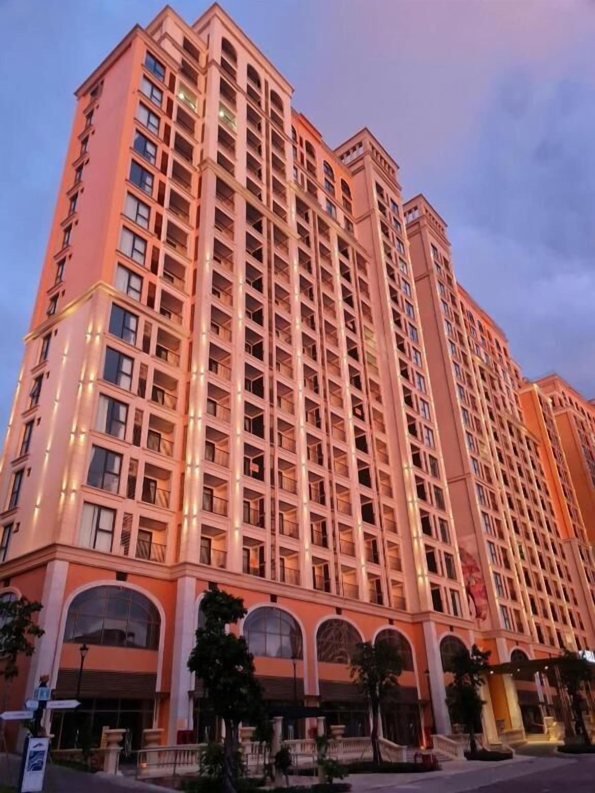 A multi-story hotel with a symmetrical facade, large windows, and a central entrance with arched windows.