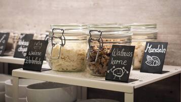 A display of food items in glass jars with labels indicating different types of chocolates and snacks.