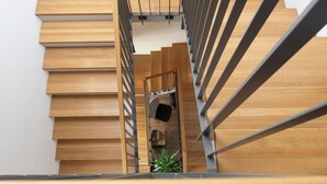 A modern staircase with wooden steps and metal railings.