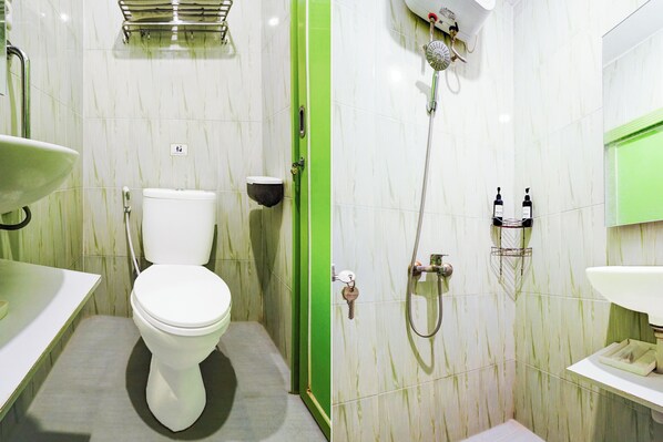 A bathroom with a toilet, sink, and shower.