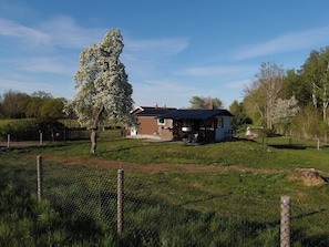 A house with a fenced yard, a tree, and a clear sky. - Live in a scenic location, close to hiking trails or cozy cafés (Västra Götalands län)