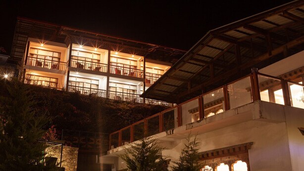 A multi-story building with balconies and large windows, likely a hotel or resort. - Zhingkham Resort (Punakha)