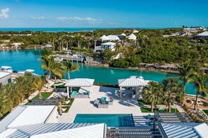Un complexe hôtelier doté d’une grande piscine, de plusieurs bâtiments et offrant une vue sur l’océan.