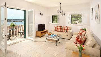 Apartment, Balcony, Sea View | Living area | 25-inch flat-screen TV with cable channels
