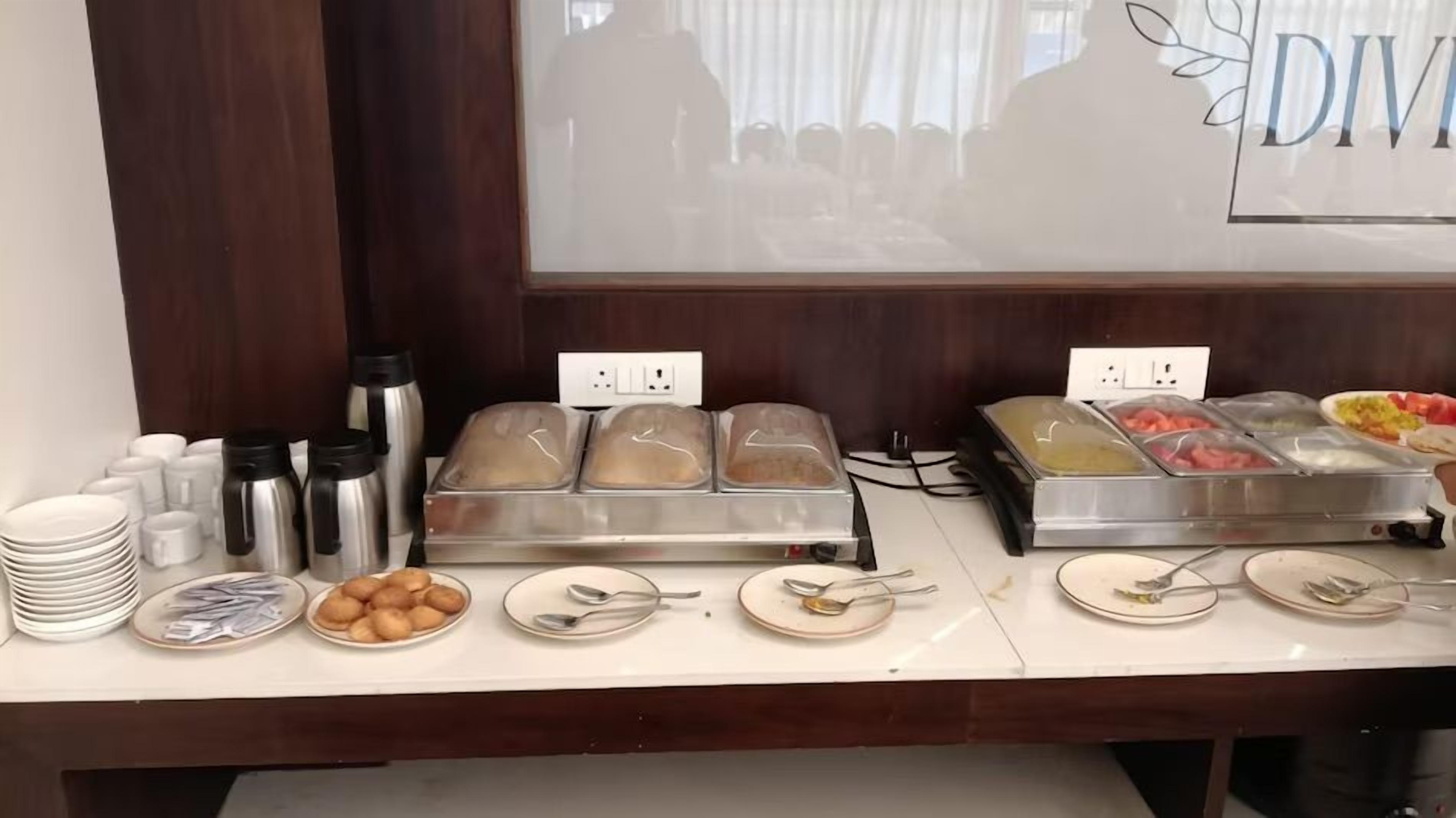 A buffet setup with various food items and condiments.