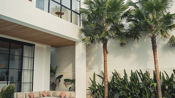A modern two-story house with a swimming pool, large windows, and a balcony. - Arrova Bali Berawa, Canggu by Sandara (Jimbaran)