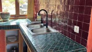 A kitchen with two sinks, a window, and a view of the outside. - The Ocean Breeze bungalow (Sidi Kaouki)