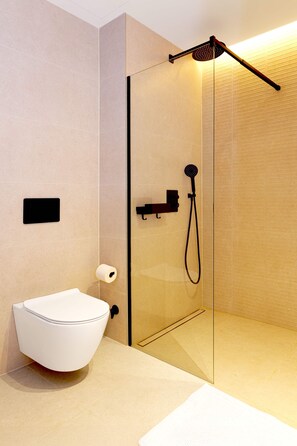 A modern bathroom with a glass shower enclosure, a white toilet, and a towel rack. - SariStays Valencia City Center L (Valencia)