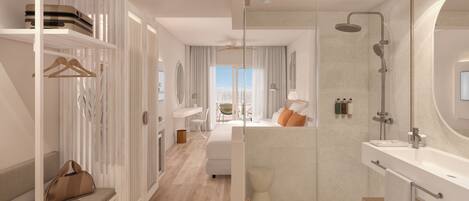 Una habitación de hotel moderna con vestidor, cabina de ducha de vidrio, un espejo grande y vistas de la ciudad.
