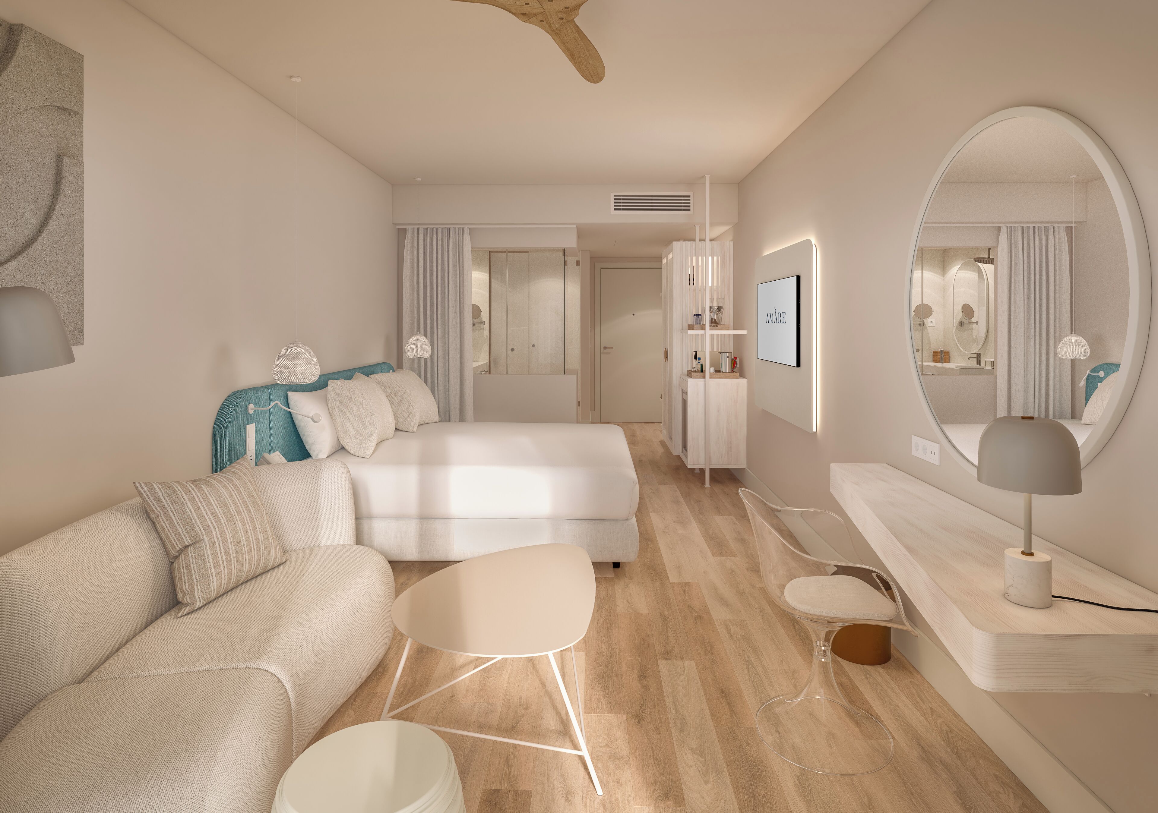 A modern hotel room with a large bed, a sofa, a small table, a chair, and a vanity with a mirror.