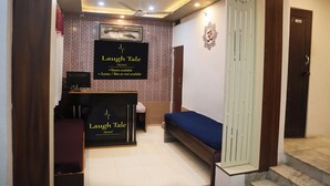 A reception area with a sign for 'Laugh Tale Hostel' and a reception desk. - Laugh Tale Hostel (Rishikesh)