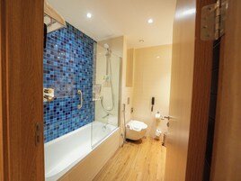Ein Badezimmer mit einer Duschkabine, einer weißen Badewanne und einer Toilette.