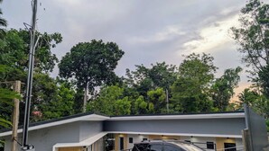 A modern building with a black SUV parked in front. - The Canyoneer Inn (Alegria)