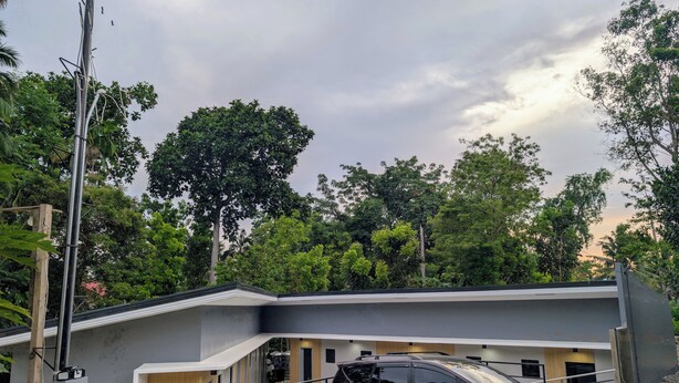 A modern building with a black SUV parked in front. - The Canyoneer Inn (Alegria)