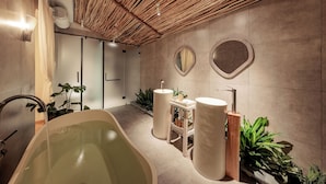 A modern bathroom with a freestanding bathtub, two sinks, and a vanity with a mirror. - La Sen Village (Nam Hoa Lu)