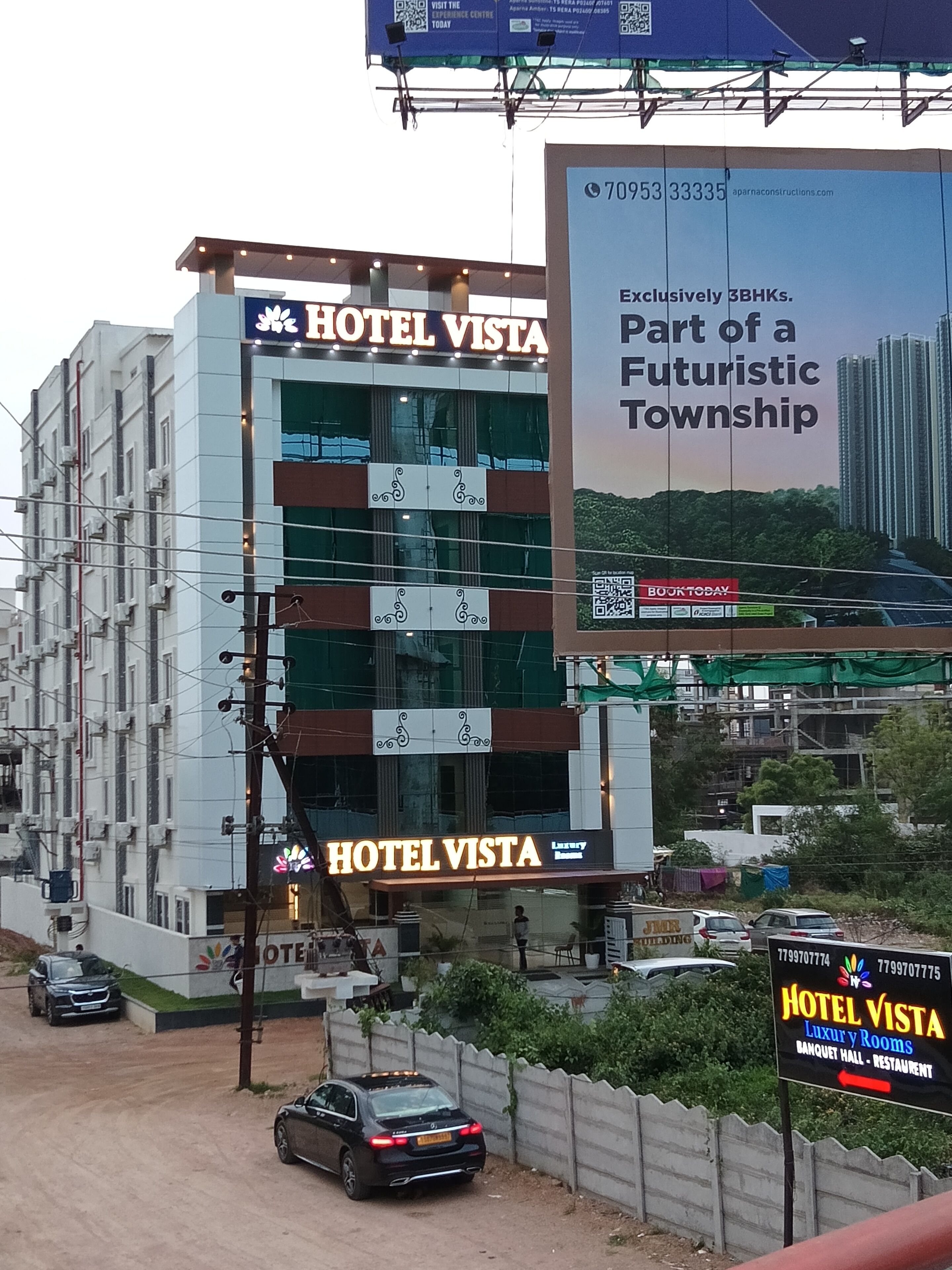 A multi-story building with a prominent sign for HOTEL VISTA.
