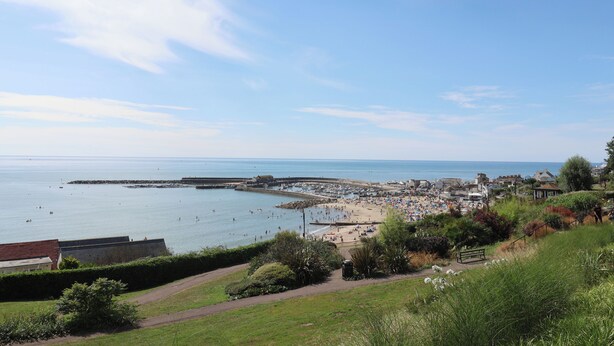 A coastal town with a beach, promenade, and sea views.