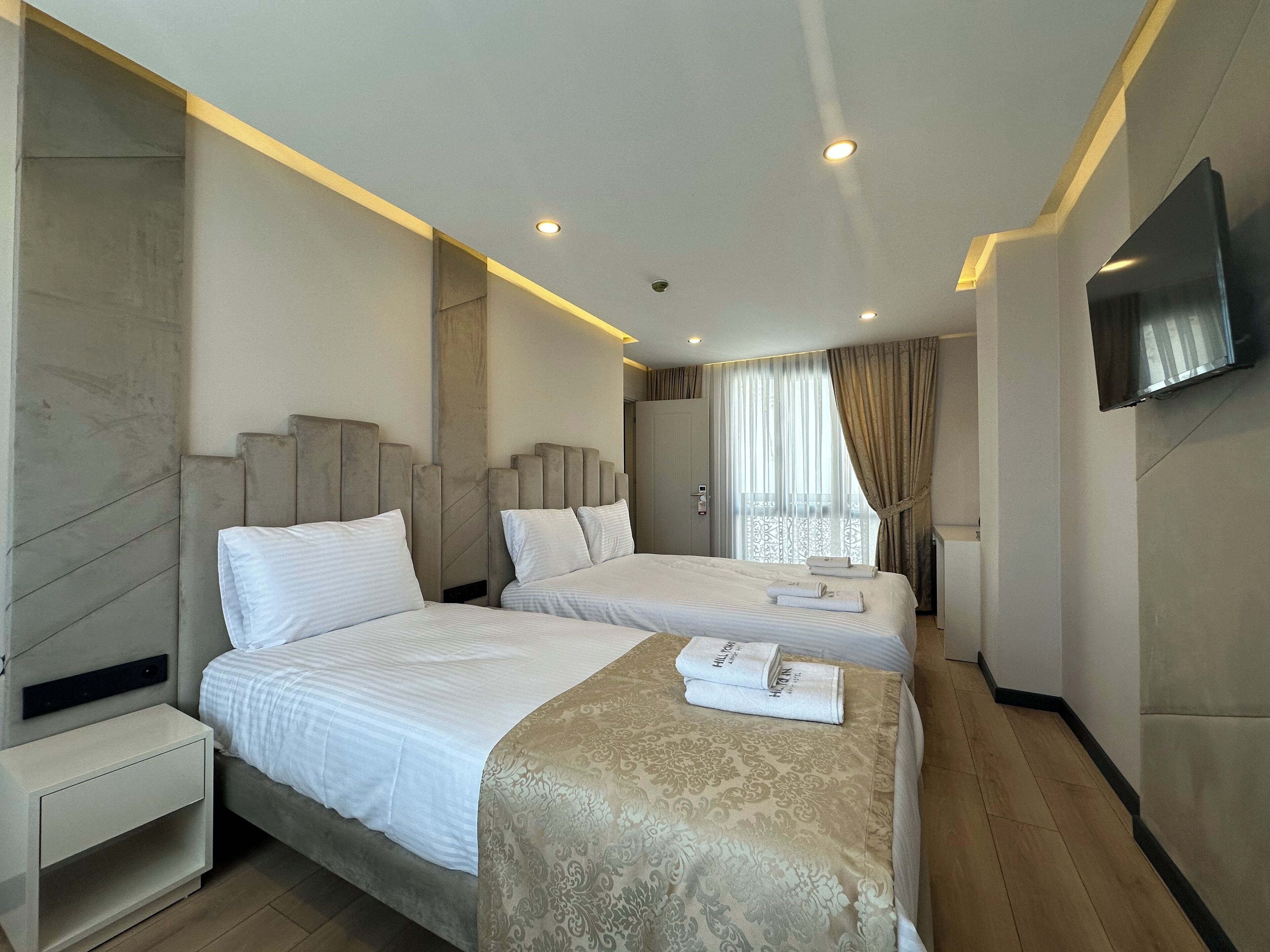 Deluxe Triple Room, City View | Desk, laptop workspace, iron/ironing board, free WiFi