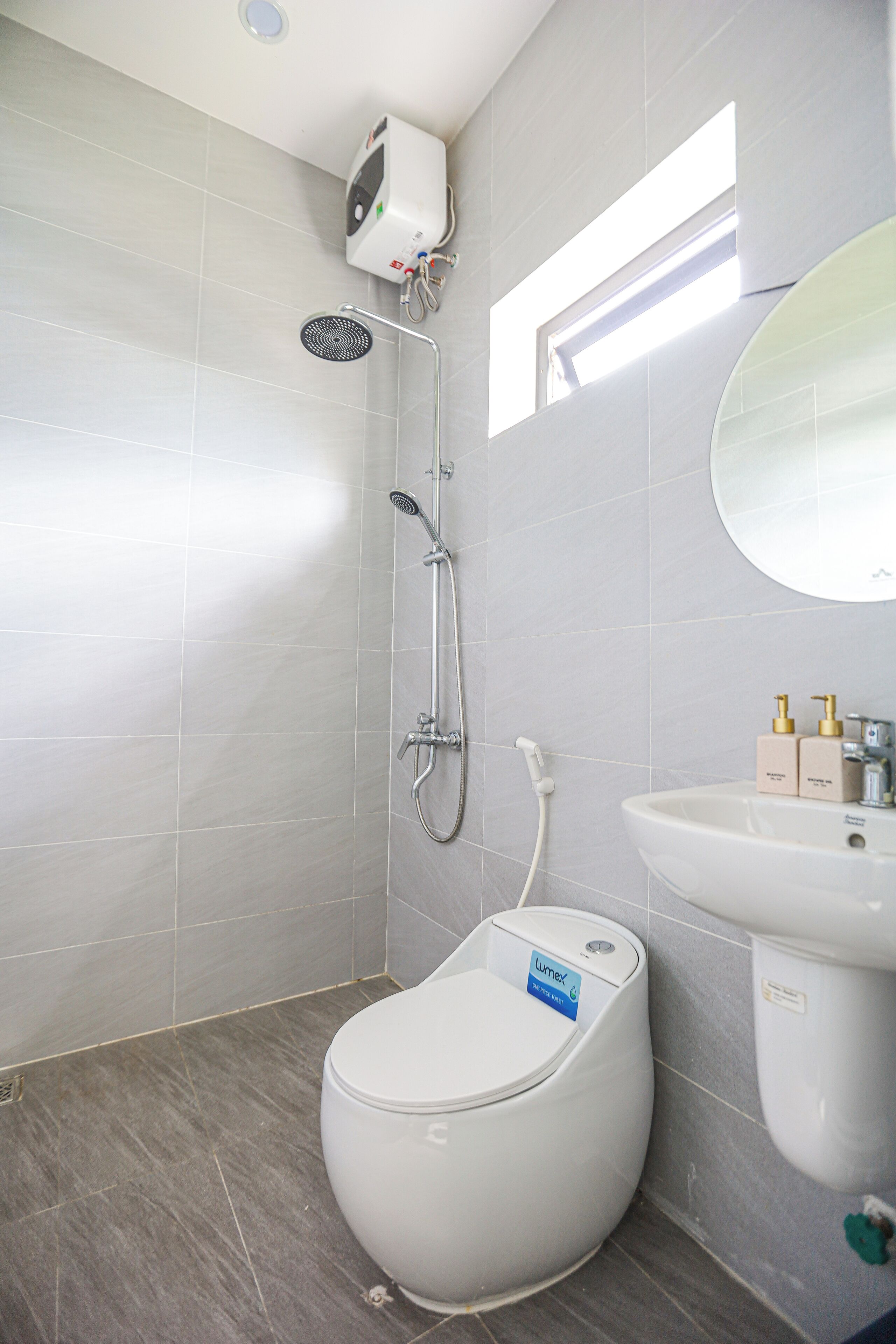 A modern bathroom with a toilet, bidet, and sink.
