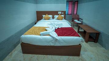 A neatly made bed with a wooden headboard, a bedside table, and a chair.