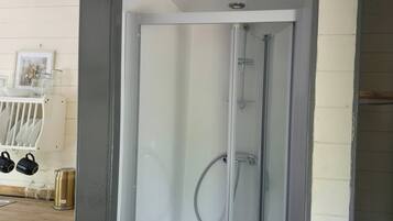 Huisje | Badkamer | Een douche, handdoeken