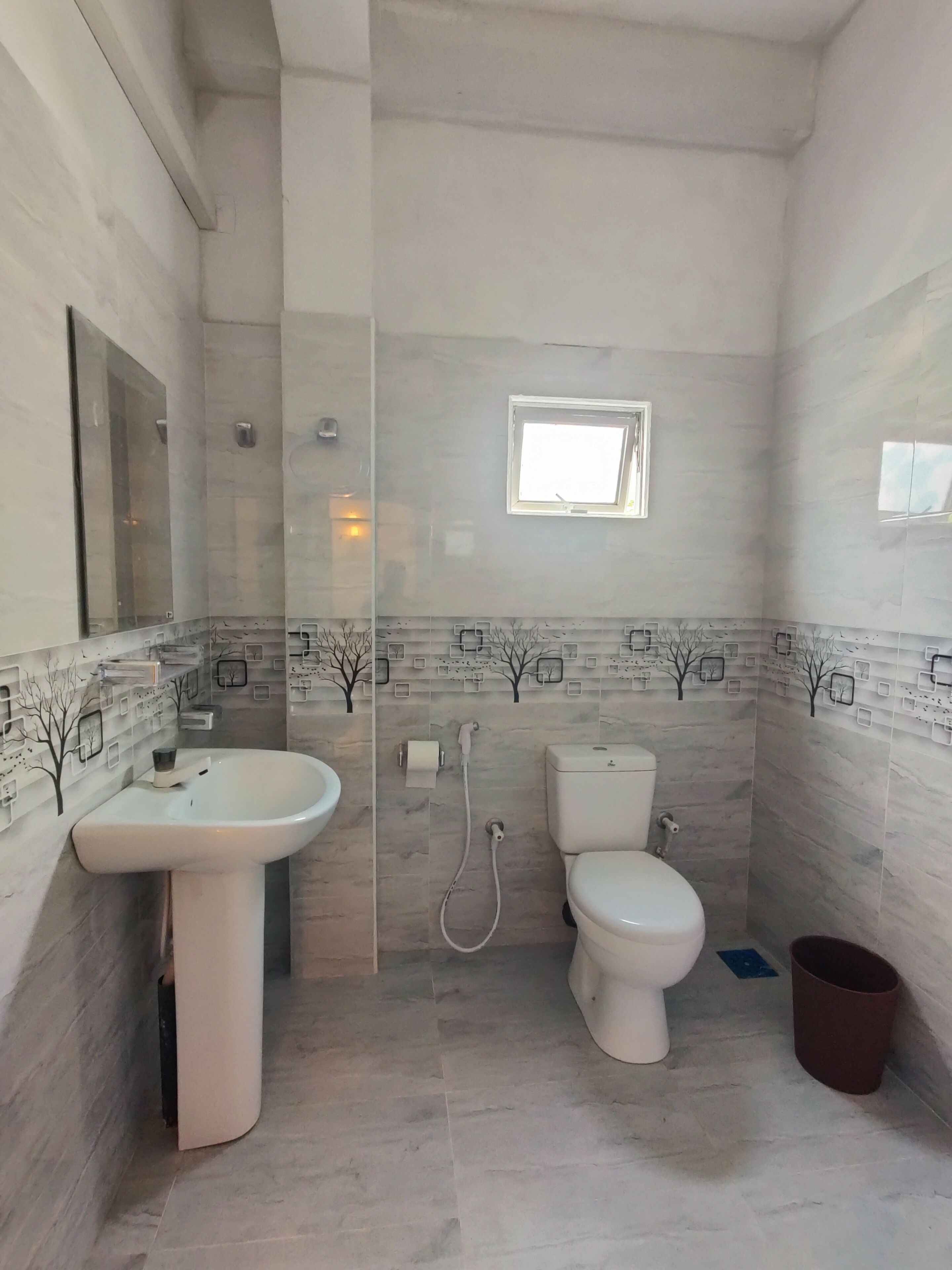 A bathroom with a sink, toilet, and shower.