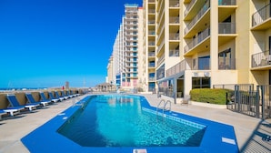 A swimming pool with blue tiles, a lifeguard chair, and a flag indicating no diving. - Phoenix Iv 4005 3 Bedroom Condo (Orange Beach)