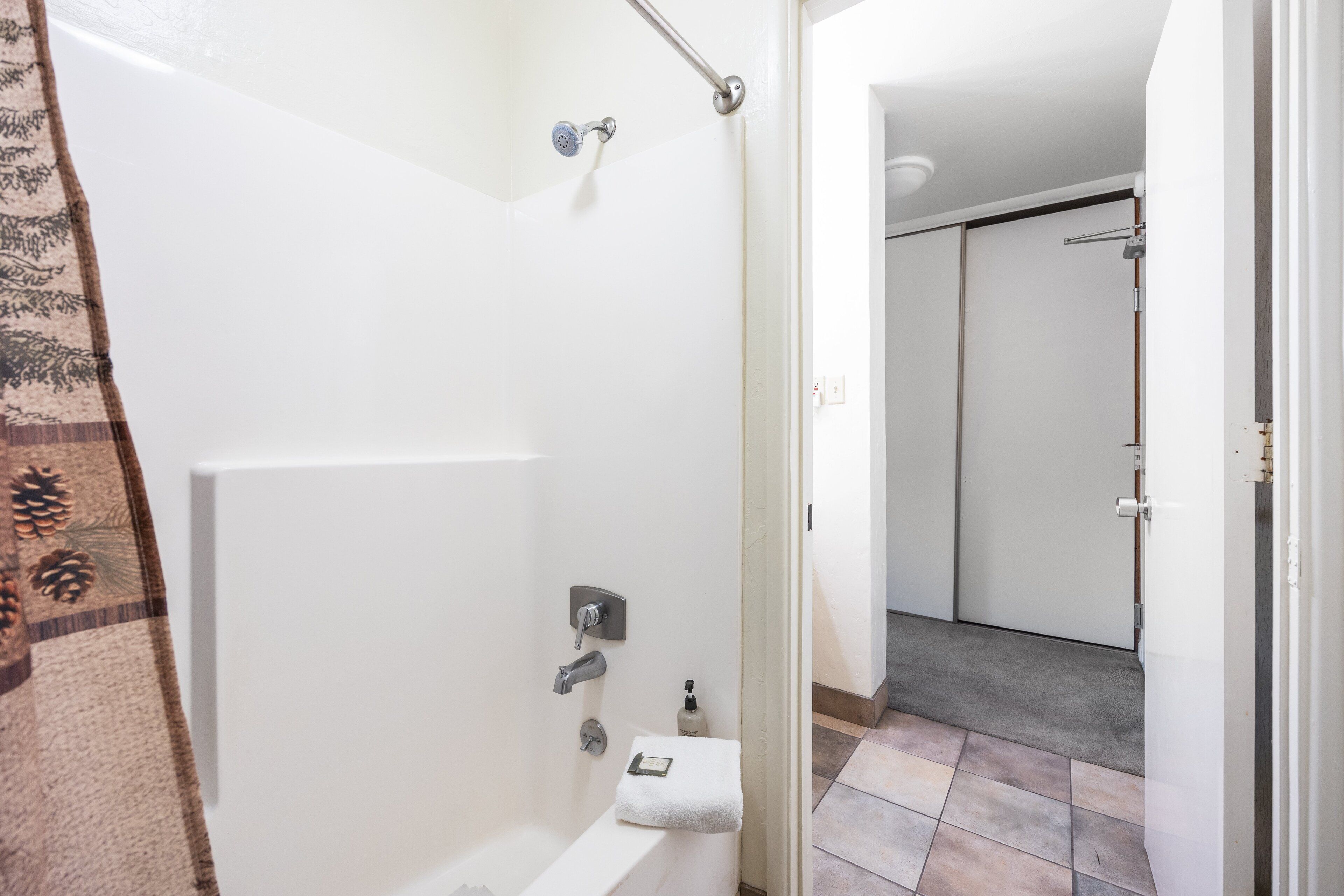 A bathroom with a bathtub, a shower, and a toilet.
