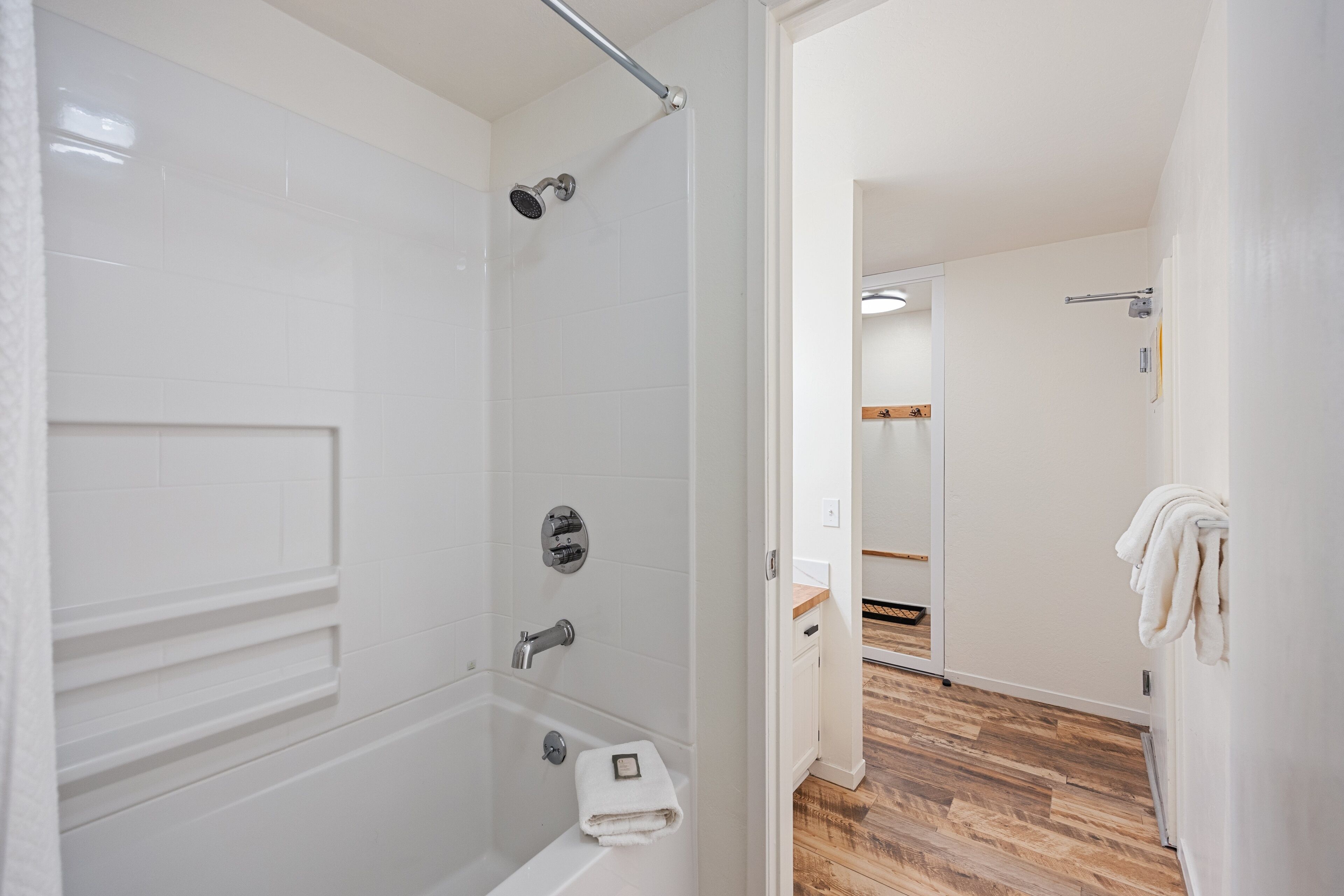 A bathroom with a bathtub, shower, and toilet.