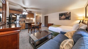 A compact living space with a kitchenette, a dining area, and a bedroom. - 113 Bldg B 1 Bedroom Studio (Truckee)
